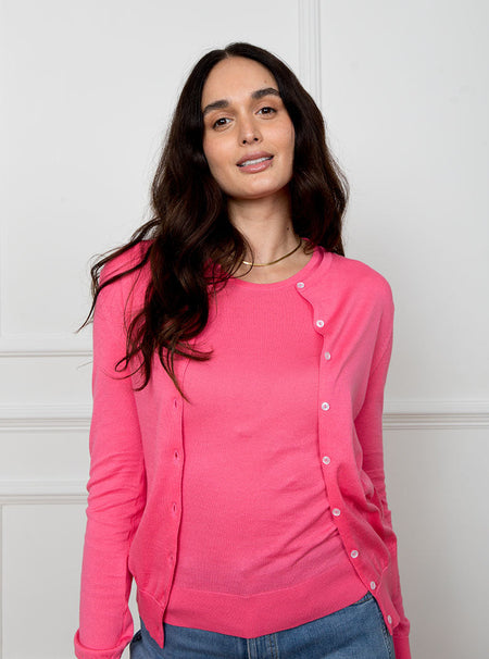 Woman wearing flamingo pink long sleeved cardigan knit top in a premium and luxury sea island cotton. Paired with matching short sleeved knit top.
